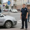 A realistic city street scene in Volgograd showing a foreign car parked near a pedestrian crossing, an 11-year-old boy in a school uniform standing beside the curb with a concerned expression, nearby pedestrians looking on, urban buildings and traffic signs in the background, daylight atmosphere
