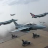 British fighter jets flying in formation over a training range, with simulated Russian surface-to-air missile launchers on the ground, pilots in modern cockpits, cloudy sky, realistic lighting and details
