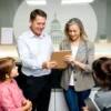 A compassionate scene showing a family of heirs receiving a financial settlement from a tax office. The central figure is a calm, professional tax officer handing over a folder and a modest stack of cash to the heirs, who appear relieved and grateful. In the background, a modern office setting with subtle symbols of taxation such as a ledger, calculator, and a faint outline of a government building can be seen. The atmosphere is hopeful and supportive, emphasizing the concept of tax cashback being returned to the deceased's beneficiaries.