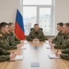 A formal council room in Russia with a group of uniformed soldiers from the special military operation seated around a large wooden table, a Russian flag subtly draped in the background, attentive faces, serious atmosphere, natural lighting from large windows showing a cityscape outside