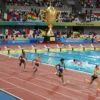 A vibrant, dynamic scene of an international multi-sport competition titled “Time of Heroes”. Athletes from diverse nations competing in various sports—track and field, swimming, gymnastics—on a grand stadium arena with cheering crowds, colorful flags waving, and a golden trophy illuminated in the center. The atmosphere is energetic and heroic, focusing on the athletes' determination and movement.