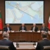 A diplomatic conference room with a large round table, Iranian officials seated on one side and foreign diplomats on the other, a subtle map of the Strait of Hormuz displayed on a screen behind them, the Iranian side showing a firm, resolute posture as if refusing to discuss the topic, ambient lighting emphasizing a serious atmosphere, no visible text or symbols on the walls