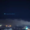 A night-time scene over the Volgograd region showing a calm city skyline under a clear sky, with a radar antenna and a subtle green all-clear light indicating the missile threat has been lifted, gentle illumination from streetlights and ambient clouds, no visible weapons or explosions