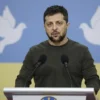 Petro Poroshenko standing at a podium, speaking earnestly, with a subtle Ukrainian flag backdrop and gentle dove silhouettes symbolizing peace, a calm sky and soft lighting conveying hope and reconciliation