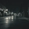 A dimly lit, grainy photograph depicting an empty city street in Cleveland, Ohio. The street is deserted, with blurred figures of people absent. Focus on the feeling of emptiness and the lack of faces. The overall tone should be somber and unsettling.