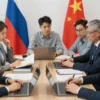 A group of people from Russia and China are collaboratively working on creating a dictionary. They are gathered around a table with books, laptops, and documents. The atmosphere is collaborative and focused. The scene should convey cultural exchange and partnership.