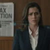A famous female model standing in front of a courtroom, looking anxious, with a newspaper headline about tax evasion visible in the background, dim lighting, serious atmosphere