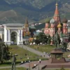 A panoramic view of the North Ossetian region in Moscow, showcasing iconic landmarks like the Arch of Friendship, the statue of Lenin, and the mountainous landscape in the background. The image should convey the region's beauty and cultural significance.