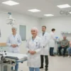 A modern hospital building in Ulyanovsk, Russia, with medical staff in white coats and patients in the background. The scene should convey a sense of hope and progress in cancer treatment. The hospital should be well-lit and equipped with advanced medical technology.