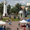 A vibrant and dynamic scene depicting various locations for the Day of Youth-2026 in Ulyanovsk. Include landmarks, parks, cultural centers, and potentially some young people enjoying themselves. The image should showcase the diversity of activities planned for the event.
