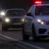 A dramatic scene of a drunk man in Bashkortostania being chased by police cars on a rural road, with flashing lights and dynamic motion, showing tension and urgency