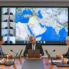 A realistic scene showing Israeli officials in a modern conference room, speaking with American officials via video call, with a large digital map of the Middle East on a screen highlighting the city of Beir, indicating strategic planning for expanded air strikes. The atmosphere is serious and diplomatic, with suited figures, laptops, and a world map backdrop. No weapons or graphic violence are visible.