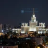 A wide shot of the Volgograd region at night, showing the city skyline with illuminated buildings. The sky should be dark with a few faint stars visible. No signs of missile strikes or explosions should be present.