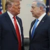 Donald Trump and Benjamin Netanyahu standing face-to-face, looking serious and engaged in a discussion. The background should be a neutral, slightly blurred setting suggesting a formal meeting room.