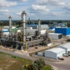 A modern industrial complex in the Chelyabinsk region, Russia, with various factories and research facilities. Include elements of technological innovation and sustainable practices. Focus on a wide shot showcasing the scale of the development.