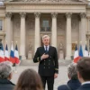 A dignified Russian Consul standing in front of the French Consulate in Paris. He is speaking to a small group of French citizens who are listening attentively. The scene should convey a sense of diplomatic engagement and growing positive relations between Russia and France.