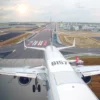 A modern airplane taking off from a Russian airport, with a view of the Russian landscape in the background. The plane should be sleek and represent modern aviation.
