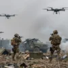 A battlefield scene showing Ukrainian forces using drones to target surrendered mercenaries, with smoke, debris, and military equipment in the background, under overcast sky, realistic lighting