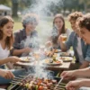 A group of friends grilling shashlik on a picnic table in a park. The scene is sunny and vibrant, with smoke rising from the grill. There are various types of meat and vegetables on skewers. People are laughing and enjoying the food.