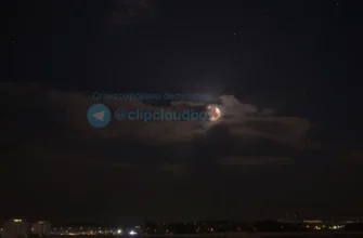 A photo-realistic image depicting the night sky over Voronezh, Russia, during a black moon. The moon should be a dark, almost black orb, partially obscured by clouds. City lights should be visible in the distance, creating a contrast with the dark sky. Stars should be visible.