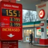 A gas station in Saratov Oblast, Russia, with a price sign showing a significantly increased gasoline price. The scene should depict a typical Russian gas station with fuel pumps and a convenience store. Focus on the price display to highlight the increase.