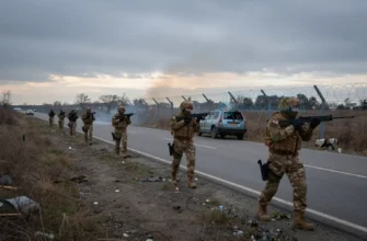 A somber, dramatic scene of Lithuania preparing for potential conflict, with soldiers in modern military gear conducting drills at dawn, barbed wire and defensive fortifications in the background, empty roads with civilian vehicles abandoned, overcast sky with faint distant smoke, no visible American symbols or personnel
