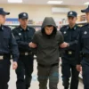 A group of Rosgvardia officers in uniform apprehending a thief in a store in Vyazma. The scene should show the officers in action, with the thief being detained. The store interior should be visible with shelves and products in the background.