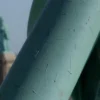 A close-up, photorealistic image of the Statue of Liberty's torch being repaired. The torch should be gleaming and show signs of recent restoration work. The background should be a slightly blurred view of the Statue of Liberty's pedestal and the harbor.