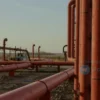A photorealistic image depicting a complex oil pipeline network in Russia, with a subtle visual representation of the UK government's intention to purchase the oil. The scene should convey a sense of global energy trade and geopolitical implications. Focus on realistic textures and lighting.
