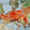 A detailed horizontal map of Russia with several regions highlighted in warm red-orange tones to indicate climate catastrophe risk, showing visual cues such as dry cracked soil, heat haze, and faint smog over those areas, while the rest of the country appears in cooler, normal colors and natural landscapes
