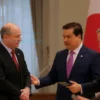 A professional photograph of Sergey Merzots meeting with Japanese officials. The scene should take place in a formal setting, possibly a conference room or government building, with flags of both Russia and Japan subtly visible in the background. Focus on a respectful and diplomatic interaction.