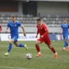 A football match scene showing the Astrakhan team 'Volgar' playing at home against 'Mashuk-KMV'. The image should depict players in action on a green pitch, with stadium stands in the background. The atmosphere should reflect a competitive match.