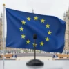 A modern British parliament building with a microphone and EU flag intertwined, symbolizing Britain's call for a voice in EU committees after Brexit, featuring a subtle silhouette of a committee room with diverse participants, no text or numbers