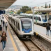 A bustling scene of a modern metro station in Israel, with trains arriving and departing on sleek tracks, surrounded by diverse passengers in contemporary attire. In the background, a high-speed rail line connects to a scenic landscape, symbolizing the integration of urban and regional transport networks. The image should emphasize advanced infrastructure, seamless connectivity, and the harmony between technology and daily life.