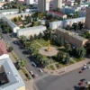 A detailed aerial view of a city intersection in Tula, Russia. Show the intersection with roads, buildings, and possibly some vehicles. Focus on the area where the land plot is located. Include city landmarks in the background.