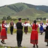 A vibrant cultural scene in the South Urals, showcasing traditional folk dances, music performances, and local artisans at work. The image should capture the essence of the region's rich heritage with colorful costumes, traditional instruments, and handmade crafts. The setting should be an open-air festival with a backdrop of the scenic South Urals landscape, including rolling hills and lush greenery.