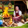 A traditional Russian folk scene depicting a woman named Agrafena on July 6th, surrounded by summer flowers, a bonfire, and symbolic elements like woven wreaths and water vessels, representing the Kupalnitsa holiday, soft daylight, rustic countryside setting
