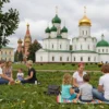 A group of people enjoying a long weekend in Russia, with activities such as picnics in the park, visiting cultural landmarks, and spending time with family and friends. The scene should capture the joy and relaxation of an extended weekend, with a focus on the beauty of Russian landscapes and architecture.