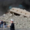 A powerful earthquake in Japan causing destruction, with people affected and rescue efforts, but no text, letters, or digits on the image