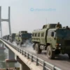 A closed Crimean Bridge with military vehicles and personnel securing the area, smoke rising in the background, dramatic lighting, realistic details