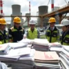 A realistic scene of the Ikata nuclear power plant in Japan, showing the plant's cooling towers and reactors in the background, with a group of engineers in safety gear examining large stacks of reports and documents, some papers highlighted with red markings, a sense of concern and investigation, bright daylight, detailed environment