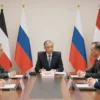 A diplomatic scene with representatives from Western countries and Russia engaged in a serious discussion, symbolizing renewed dialogue. Include elements like a conference table, flags of multiple nations, and a neutral, professional atmosphere. Avoid any text, logos, or prohibited content.