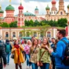 A vibrant scene from the travel show 'Кто куда' on TNT, showcasing the historic city of Smolenks. The image should capture the essence of the city with its iconic landmarks such as the Assumption Cathedral and the Smolensk Kremlin. Include a diverse group of people exploring the city, capturing the lively atmosphere and cultural richness. The scene should be dynamic, with people walking, taking photos, and enjoying local street food. The architecture should be detailed, highlighting the unique b