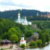 A scenic view of Vologda Oblast, Russia, showcasing its natural beauty and cultural landmarks. Include elements such as the Volga River, lush green forests, traditional Russian architecture, and possibly a historic church or fortress in the background. The image should reflect the region's serene and picturesque environment.