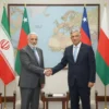 A diplomatic meeting scene showing Iranian and Omani officials shaking hands in a formal setting, with flags of Iran and Oman displayed prominently, modern conference room background with maps of the Strait of Hormuz, professional business attire, serious yet hopeful expressions, symbolizing progress in maritime negotiations