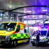 A modern hospital emergency room in Berlin with medical staff attending to patients, ambulances and helicopters arriving at the hospital entrance, conveying urgent medical response