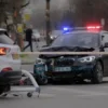 A realistic photo of a serious traffic accident in the city of Surgut, showing a collision between two vehicles on an urban road, with emergency lights flashing, police tape, and a somber atmosphere, no text or signs visible