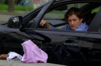 A chaotic scene depicting a drunk driver in a car, with discarded underwear on the ground. The car is parked on a street. Focus on the driver's distressed expression and the surrounding environment.