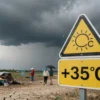 A weather warning sign in a Russian region showing extreme heat with temperatures reaching +35°C, dark storm clouds gathering in the sky, and hailstones falling, with people seeking shelter and dry cracked earth in the foreground, conveying urgency and natural danger