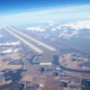 Aerial view of a region with more than ten closed airports, showing empty runways and terminals, with a focus on the southern part of the area. The image should depict a sense of abandonment and lack of activity, with no visible air traffic or passengers.